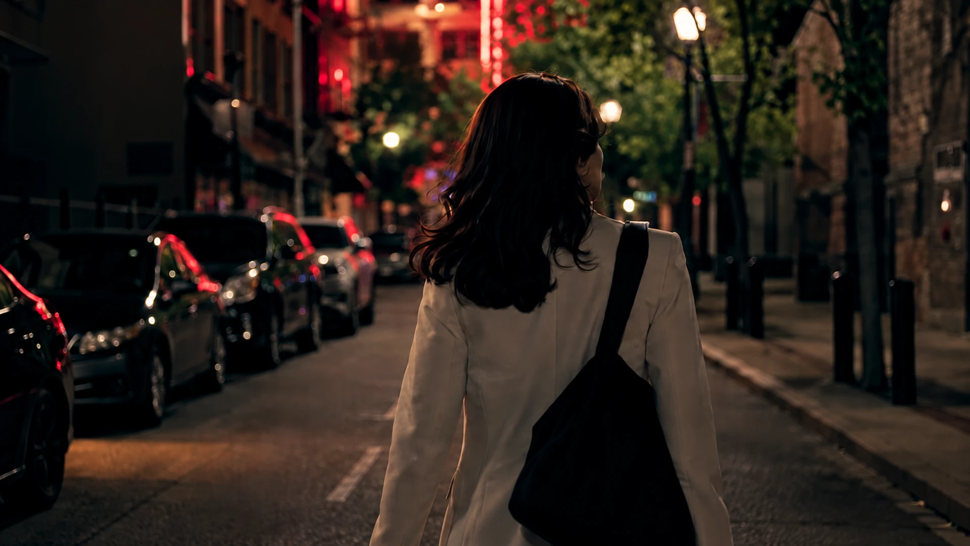 Cinematic production by REALPRO Studios featuring a woman walking through a city street at night.
